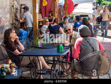 Visitors enjoying food & drink at Benson's Tavern & Beer Garden, an outdoor cafe, during the annual small town ArtWalk Festival Stock Photo