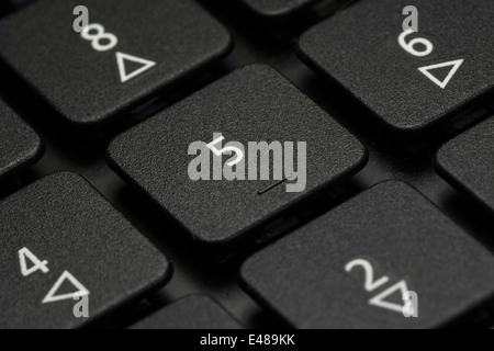 Macro-photo of computer laptop / desktop numeric keys detail. Exact focus on '5'. Stock Photo