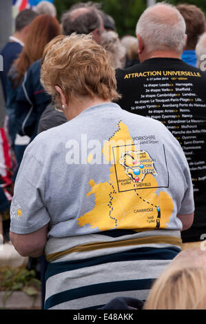 Burley-In-Wharfedale, Yorkshire, England, UK. July 5th 2014. Rear view of spectators on the stage one route of the Tour De France. Man & woman both wearing t-shirts promoting the event. Credit:  Ian Lamond/Alamy Live News Stock Photo