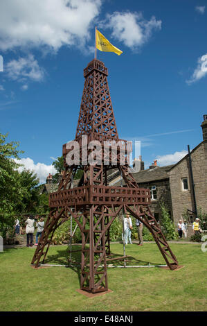 Impressive wooden Eiffel Tower model built to celebrate Le Tour in Yorkshire, is central feature of private garden, being viewed by people during open day to raise money for local charity (scout & guide group) - Burley-In-Wharfedale, England, UK. Stock Photo