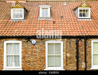 A house front, roof tiles and dormer windows inset into the roof. York, North Yorkshire, United Kingdom. 2014-07-05 Stock Photo