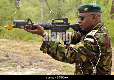 A Kenyan soldier equipped with Deployable Instrumentation System rifle fires blanks during exercise Silent Warrior at the Grafenwoehr Training Area June 20, 2014 in Bavaria, Germany. Stock Photo