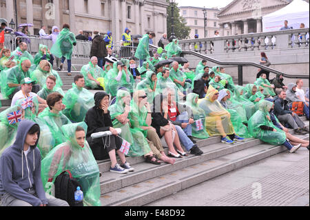 Trafalgar Square, London, UK. 5th July 2014. The rain doesn't put off the Tour de France fans watching at one of the official Fan Parks in London. Credit:  Matthew Chattle/Alamy Live News Stock Photo