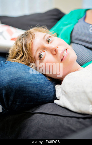 Female couple lying on sofa Stock Photo