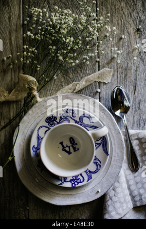 Still life of coffee cup and bunch of flowers Stock Photo