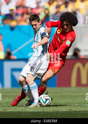 Brasilia, Brazil. 5th July, 2014. Argentina's Lionel Messi (L) vies with Belgium's Marouane Fellaini during a quarter-finals match between Argentina and Belgium of 2014 FIFA World Cup at the Estadio Nacional Stadium in Brasilia, Brazil, on July 5, 2014. Argentina won 1-0 over Belgium and qualified for the semi-finals. Credit:  Qi Heng/Xinhua/Alamy Live News Stock Photo