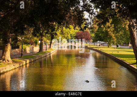 Bourton on the Water with the River Windrush running through the centre with small stone bridges for crossing Bourton on the Water Gloucestershire UK Stock Photo