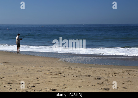 Man fishing on seabright beach, on east cliff in Santa Cruz, Pacific Ocean Stock Photo