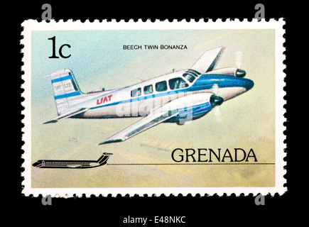 Postage stamp from Grenada depicting a Beech twin bonanza airplane in flight Stock Photo