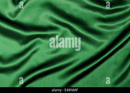 Green Silk background texture with wavy ripples to enhance the sheen of the fabric. Stock Photo