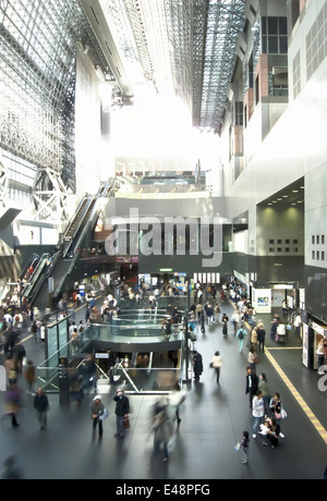 Crowds of commuters are rushing through the busy hall of Kyoto main station, Japan. Stock Photo