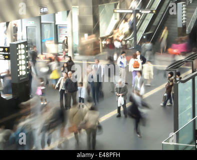 Crowds of commuters are rushing through the busy hall of Kyoto main station, Japan. Stock Photo