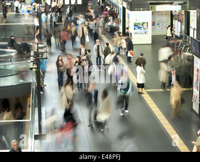 Crowds of commuters are rushing through the busy hall of Kyoto main station, Japan. Stock Photo