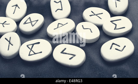 rune stones with black symbols for fortune telling Stock Photo - Alamy