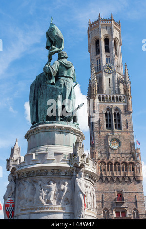 Bruges - The Belfort van Brugge and memorial of Jan Breydel and Pieter De Coninck on the Grote Markt square Stock Photo