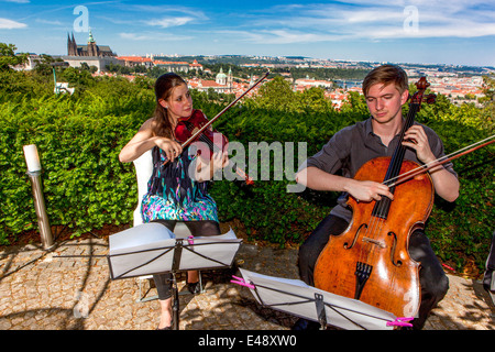 View of Prague from the Petrin restaurant Nebozizek. In the background, Prague Castle Czech Republic Musicians Stock Photo