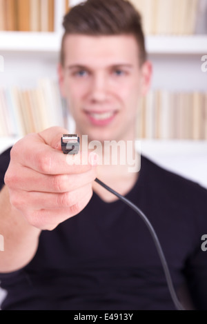 man holding and showing black USB cable, usb port connector Stock Photo