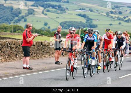 Addingham, Yorkshire, UK. 6th July, 2014. Lead group of cyclists led by Bart de Clercq and David de la Cruz Melgarejo climb the hill out of the village of Addingham on Day 2 of the Tour de France Credit:  Christina Bollen/Alamy Live News Stock Photo