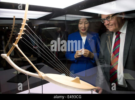 German Foreign Minister Frank-Walter Steinmeier (SPD, R) and Mongolian Minister of Culture, Tsedevdamba Oyungerel, examine a so-called Altai harp, as they tour through the exhibition 'Kulturerbe der Steppenkrieger' (cultural heritage of the warriors of the steppe) at the Mongolian national museum in Ulan Bator, Mongolia, 6 July 2014. The exhibition showcases archaeological findings of rock cut tombs whoch were discovered by restored by Mongolian and German archaeologists and historians. One of the most important exhibits at the museum is the around 1000 year old Altai harp. Steinmeier is on a Stock Photo