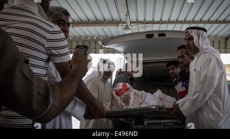 Sanabis, Bahrain. 6th July, 2014. The body of Martyr Abdulaziz Al Abbar, noted that Abdul Aziz Al Abbar was killed by a gunshot fired by Bahraini security forces on February 23 and entered the hospital for 55 days and announced his death on April 18 where authorities detained his body for a period of 78 days, Tens of thousands of bahrainis participat in the funeral march ( Photo by Hussain Albahrani/Pacific Press/Alamy Live News) Stock Photo