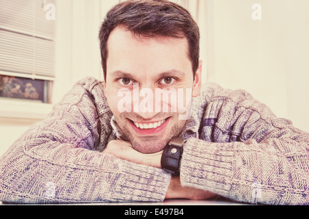 closeup of smiling handsome middle aged man relaxing indoors Stock Photo