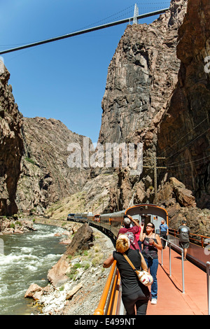 Passengers on open-air car of Royal Gorge Route Railroad; Royal Gorge and Royal Bridge; Arkansas River, Canon City, Colorado USA Stock Photo