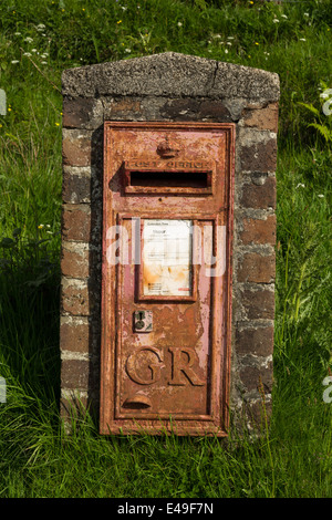 Old rusty GR post box at Cleadale on the Isle of Eigg in Scotland. Stock Photo