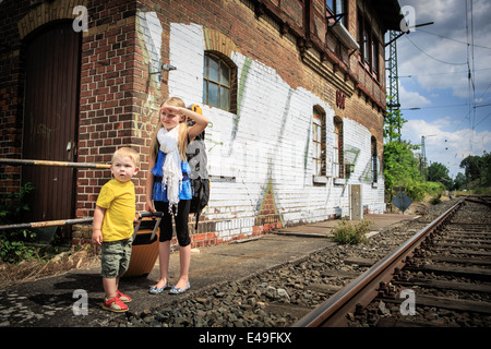 children waiting for the train on a railway station Stock Photo