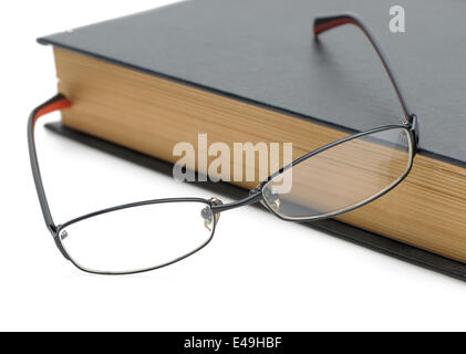 Eyeglasses on the old thick book