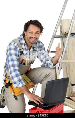 Happy laborer using computer Stock Photo