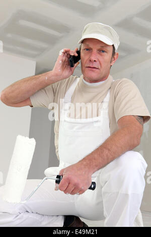 Painter making telephone call Stock Photo