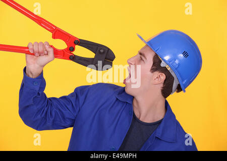 Man holding bolt cutters Stock Photo