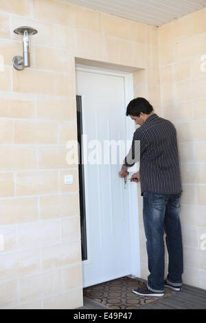 Man locking his door Stock Photo