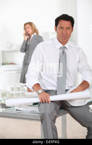 Architect sat on desk Stock Photo