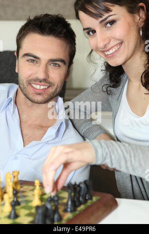 Pensive woman sitting at table in living room while thinking about next  chess move. Stock Photo by DC_Studio