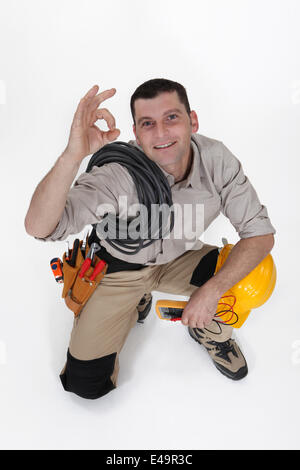 An electrician doing an ok sign. Stock Photo