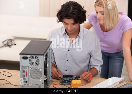 Motherboard measure. Man repairing computer hardware Stock Photo - Alamy