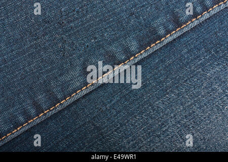 Worn blue denim jeans texture with back pocket and zipper