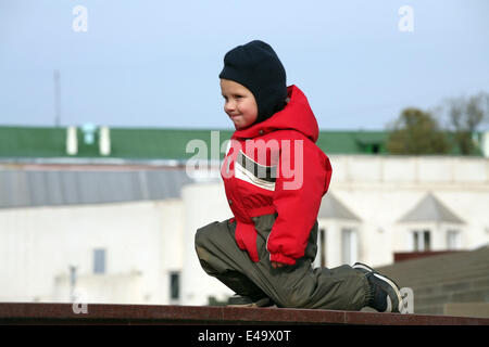 boy is dressed in warm clothes playing Stock Photo