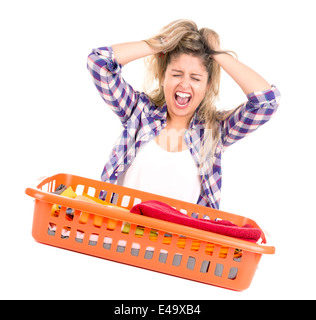 Tired young woman doing the laundry at home Stock Photo