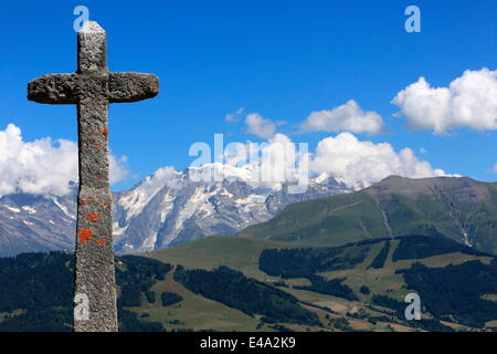 Stone cross on the Jaillet facing Mont Blanc, Megeve, Haute-Savoie, France, Europe Stock Photo