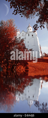 landscape and the moon and the church in the infrared spectrum.reflection in the water Stock Photo