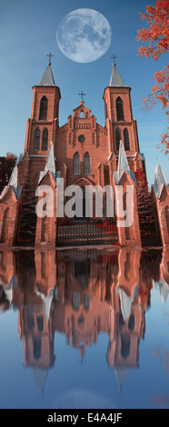 landscape and the moon and the church in the infrared spectrum Stock Photo