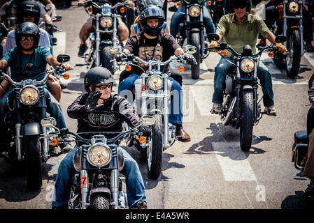 Barcelona, Spain. July 6th, 2014: Motorcyclists greet as they take part in the 'Grand Flag Parade' of the Barcelona Harley Days. Credit:  matthi/Alamy Live News Stock Photo