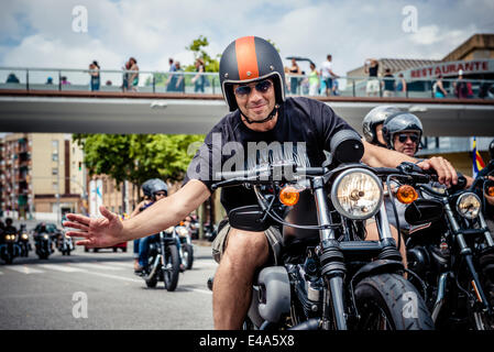 Barcelona, Spain. July 6th, 2014:Motorcyclists greet as they take part in the 'Grand Flag Parade' of the Barcelona Harley Days. Credit:  matthi/Alamy Live News Stock Photo