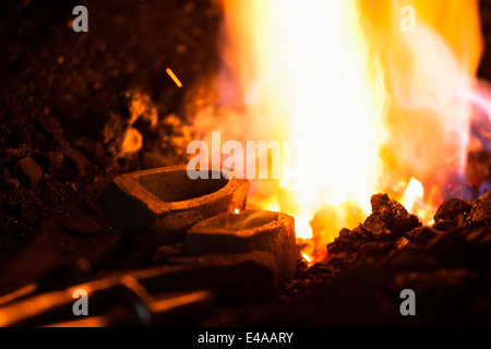 Germany, Bavaria, Josefsthal, fire at forge in historic blacksmith's shop Stock Photo