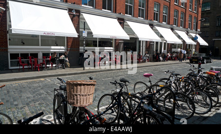 People sitting at tables outside Albion cafe bakery and food store on Boundary Street Shoreditch East London UK  KATHY DEWITT Stock Photo