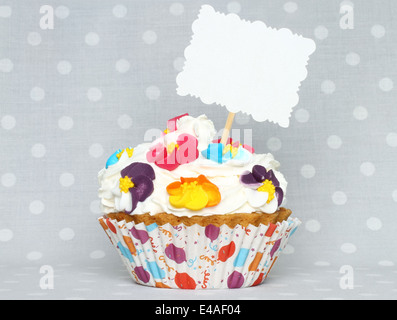 Cupcake with blank card on vintage retro background Stock Photo