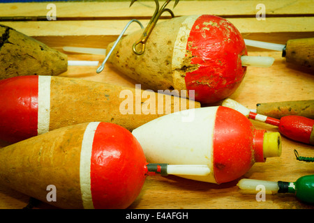 Old fishing buoys and fishhooks on wooden background Stock Photo