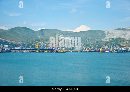Russia Novorossiysk shopping mountains city port cranes ships transportation cargo logistics black sea bay Tsemess marine contai Stock Photo